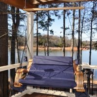 Loveseat Lounger hanging from porch at lake.